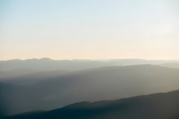 Misty Mountains Landscape in Soft Morning Light with Hazy Atmosphere for Serene Background