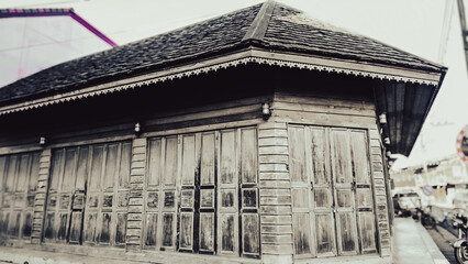 Old wooden traditional house with weathered texture, vintage architecture, cultural heritage and nostalgic rural atmosphere.