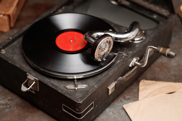 Gramophone for playing records in suitcase. Selective focus.