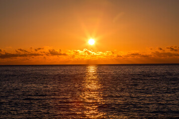 Fototapeta premium Sunrise reflected in the ocean