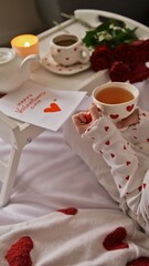 Cozy Valentine's Day breakfast in bed with tea, roses, and a heartfelt note