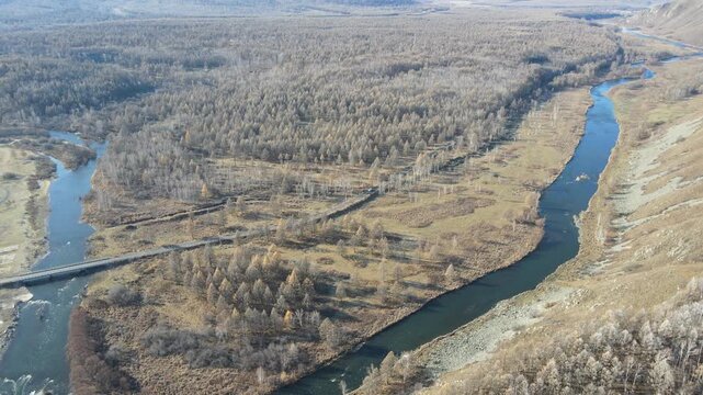 Aerial Pull Back Revealing Halaha River and Forest Valley in Autumn, Inner Mongolia, China