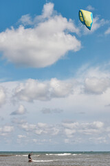 Mature man practicing kitesurfing. Aquatic sport. Athletic healthy senior
