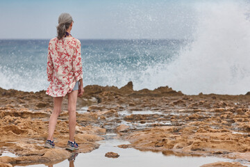 Mature woman looking the sea. Retiremet pensioner elderly. Relaxing lifestyle