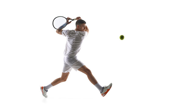 Tennis player mid air backhand swing isolated on white background. Concept of dynamic stroke execution, jump timing drills, tennis movement training, athletic performance visuals.