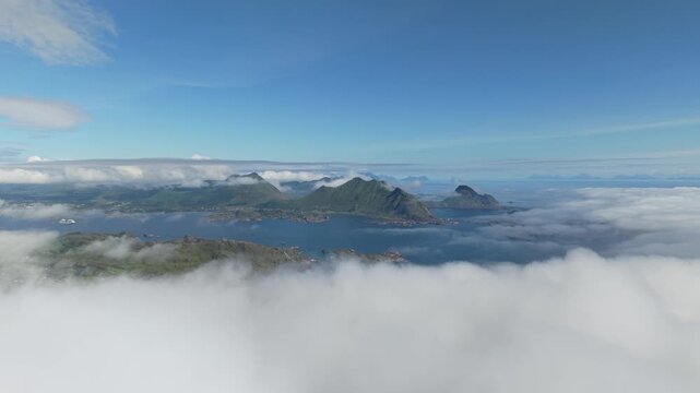 Clouds And Fog Over Mountain Peaks, Fjords, And Lush Green Islands Surrounded By The Norwegian Sea In Lofoten, Norway. - aerial shot
