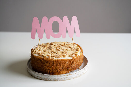 Happy mothers day concept with celebrate homemade cake with mom text