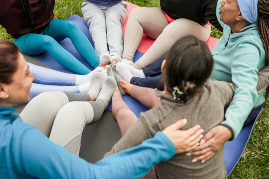 Women's circle during a group yoga class with people of different age and body types - Healthy lifestyle and meditation concept - Main focus on feet