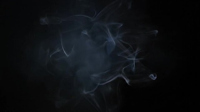 Bright orb radiating light through wispy, smoky texture against a dark, undefined background