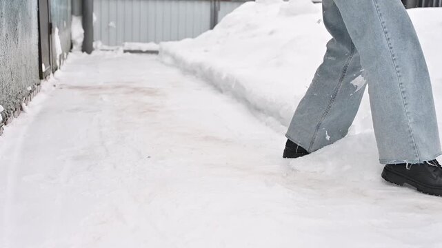 Woman falling on icy road in winter, dangerous conditions and pedestrian accident concept
