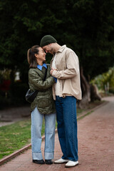 Happy interracial couple enjoying romantic moment in park