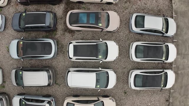 Big huge parking lot with many new cars, factory auto, dealerships salon outdoor, automotive sales industry. Transport terminal. Top aerial drone view. Long rows decommissioned vehicles, scrap metal.
