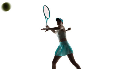 Female tennis player mid air hit with racket in studio. Concept of sports performance promotion, tennis academy marketing, fitness motivation visuals and youth training content.