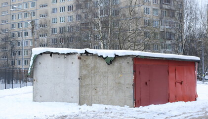 Concrete garage with metal doors in the courtyard of an apartment building