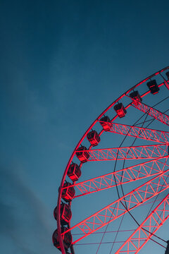 Ferris wheel detail against dramatic evening sky