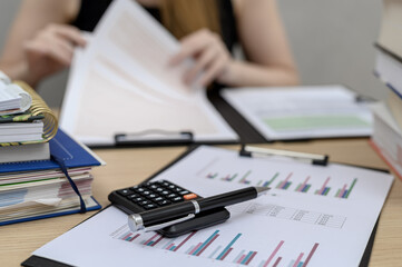 Fototapeta premium An accountant sitting at her desk at work, doing annual tax returns, training in KSEF