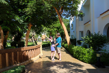 A man and a woman at a resort hug while standing.