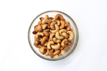 Cashews in a bowl. Roasted and salted cashews. A healthy snack. On a white background.