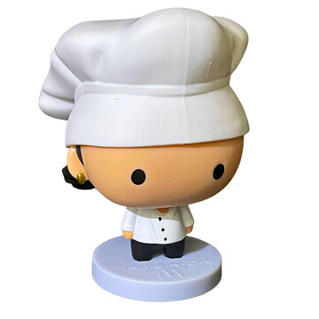 ZVIAHEL, UKRAINE - JANUARY 27, 2026: 3D-style plastic toy figurine of Monica Geller from "Friends" TV series wearing a chef hat, isolated on a plain background. McDonald's branding visible on the base