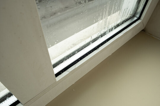 Close up of misted window glass with water streaks and droplets