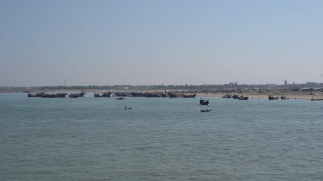Fishing boats at Cox&rsquo;s Bazar jetty along the Bay of Bengal, traditional wooden boats and coastal life in Bangladesh