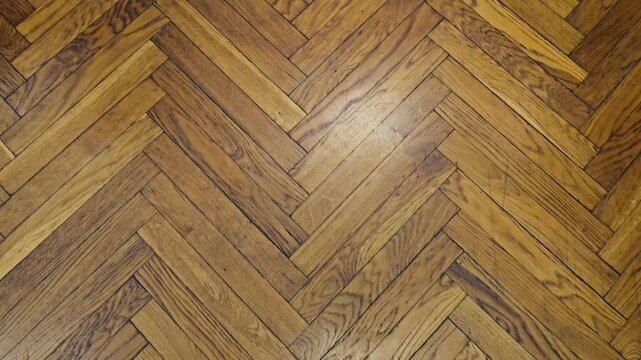 View of wooden herringbone floor pattern in a bright room during daylight