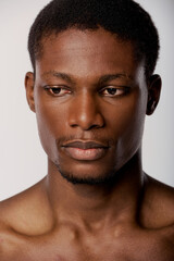 Obraz premium Handsome young man with striking features poses against a simple background