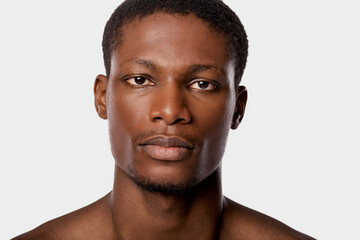 Obraz premium Handsome young man poses with confidence against a neutral background