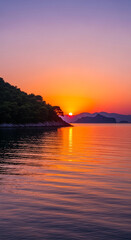 Scenic shot of a red sunset over a calm sea with a tree-covered cliff on the left, reflecting light and warmth, representing peace and new beginnings