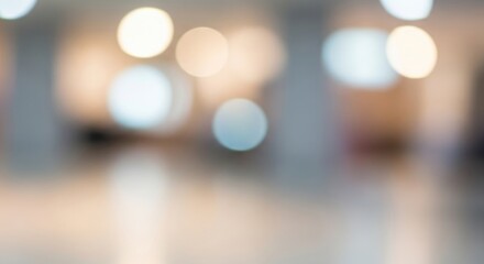 A blurred image of a room with a light-colored floor and a white wall.