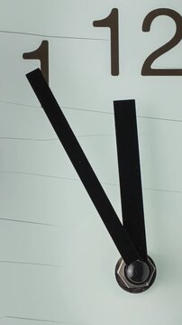 Left-to-right camera movement timelapse across a minimalist wall clock face. Smooth motion and shifting numbers symbolize time passing, continuity, and steady progression.