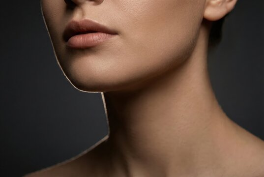Dramatic close-up of woman&rsquo;s jawline lips and neck luxury skincare beauty concept