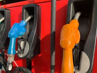 Close-up of fuel dispenser nozzles at a gas station