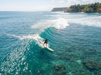 A surfer rides an ocean wave, a man conquers nature, lifestyle, freedom.