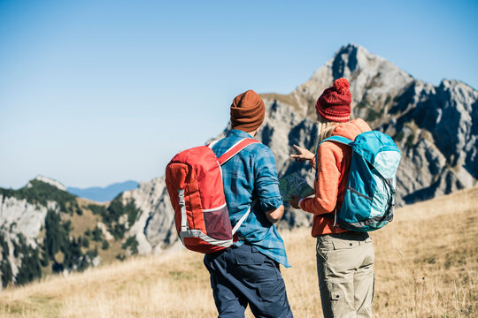 Austria, Tyrol, couple with map hiking in the mountains