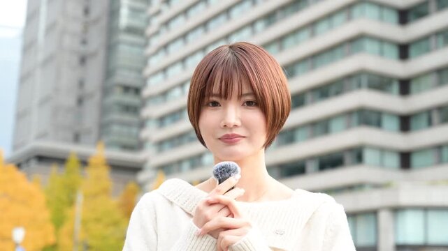 カメラ目線でピンマイクを使って話す日本人女性