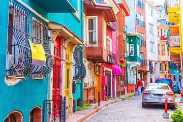 Colorful houses in the Balat and Fener districts. Tourists stroll the narrow streets.