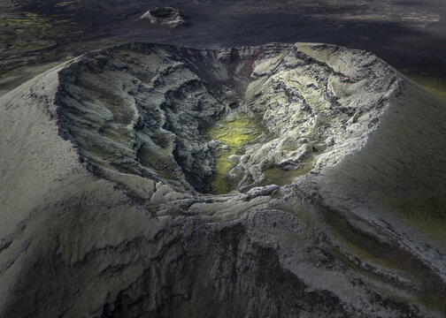 Aerial view of a desolate volcanic crater, its rugged slopes etched with shadows, a stark reminder of Iceland's fiery heart, Flugir, Rangarthing ytra, Iceland.