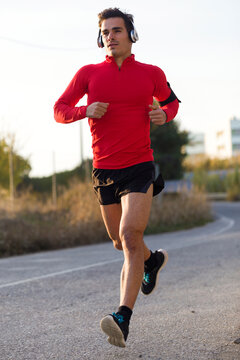 Jogger with smartphone in arm pocket and headphones