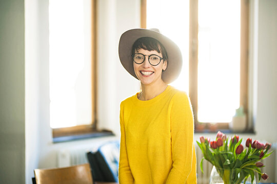 Portrait of happy stylish woman at home