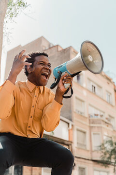 Mature man using megaphone and screaming