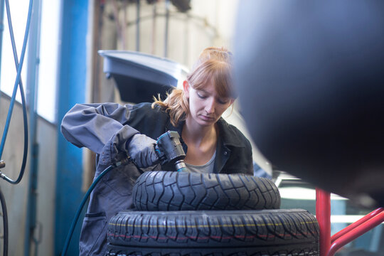 Female car mechanic working in repair garage