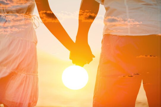 couple holding hands on beach background