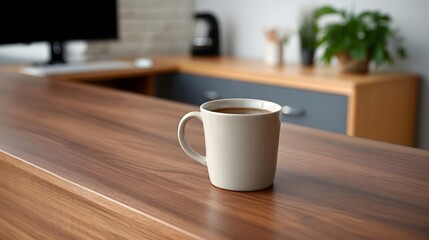 Fototapeta premium A beige mug of coffee sits on a modern wooden desk in a blurred office setting