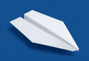 A White Paper Airplane Resting Diagonally Against A Solid Blue Background