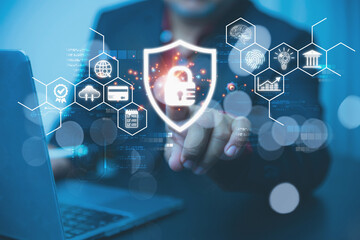 A businessman interacting with a virtual screen that features a glowing shield and padlock icon.