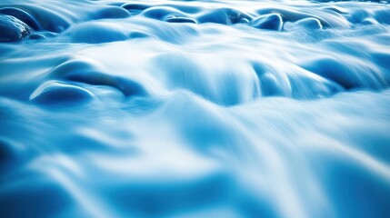 Obraz premium Abstract flowing currents of pure water captured with long exposure creating a soft blue textured background