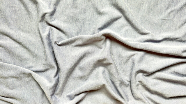 wrinkled gray fabric folds texture abstract closeup soft drapery waves minimalist neutral tones serene composition