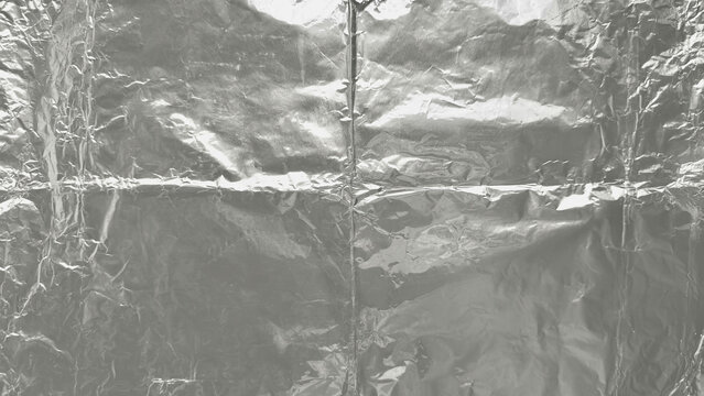 crumpled aluminum foil texture with soft reflections minimalist metallic background flat lay