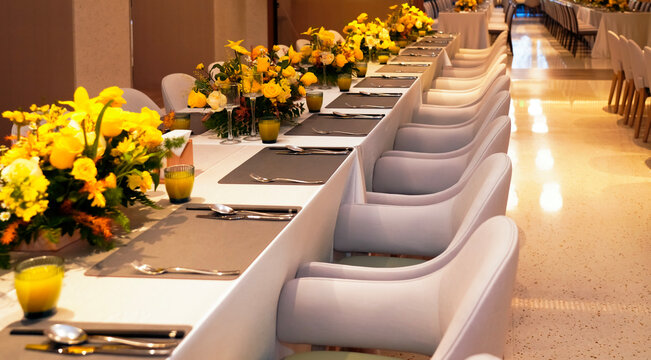 A buffet restaurant with yellow flowers on the tables